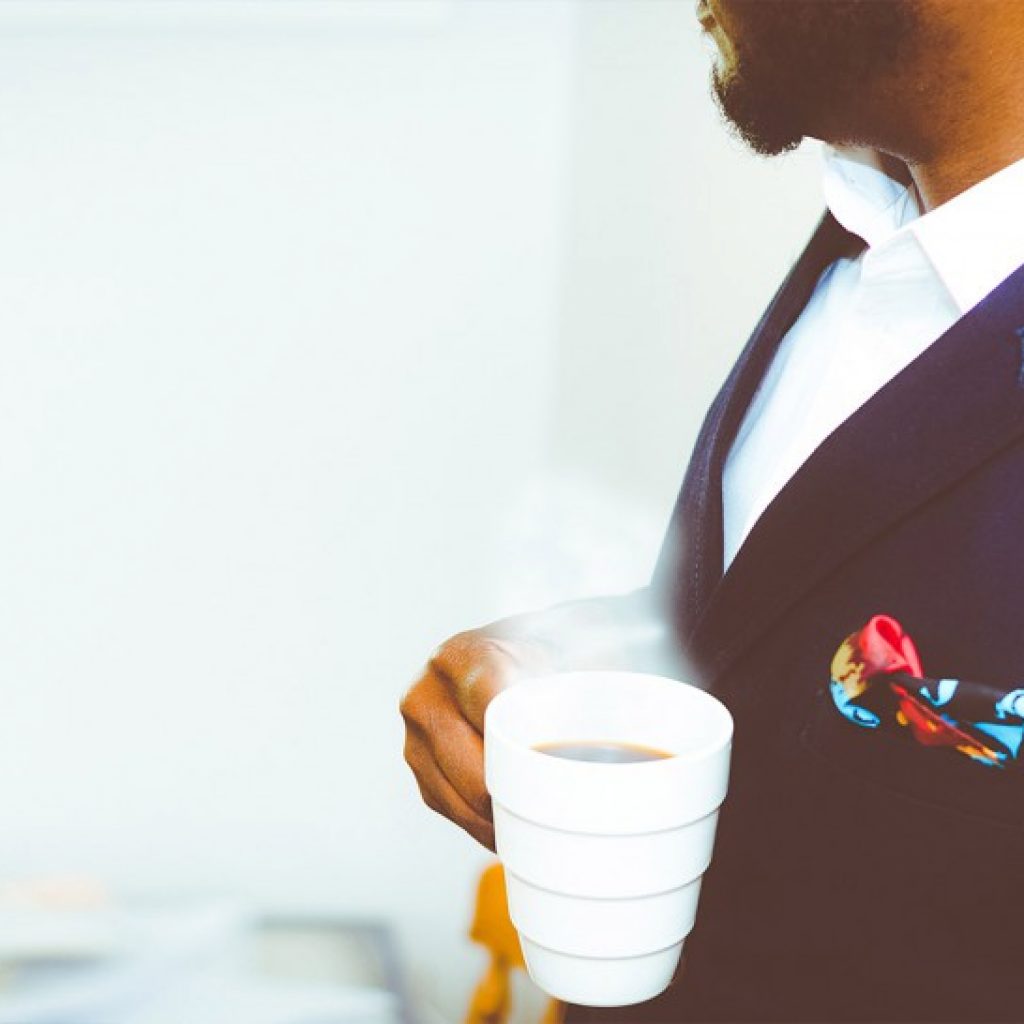 Man carrying a cup of coffee