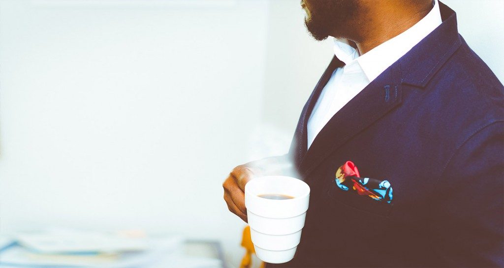 Man carrying a cup of coffee