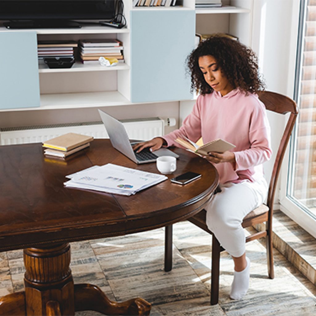 Here's How South African Insurance Companies Are Making Your Life Easier During Lockdown Person sitting at a table on the computer
