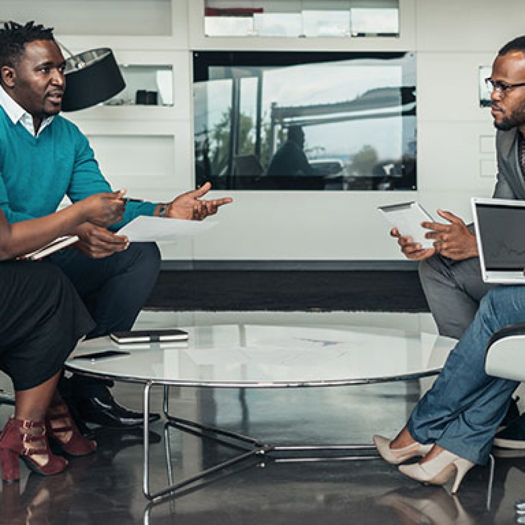People in an office having a discussion.