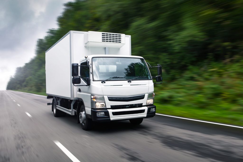 Cargo truck moving on road.